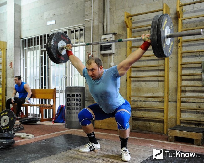Спортсмен выполняет толчок штанги