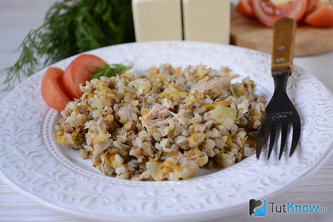 Порция готовой гречки с тушенкой и морковкой