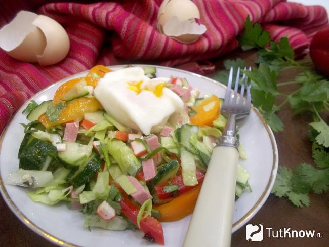 Готовый салат с крабовыми палочками, колбасой, капустой, помидорами и яйцом-пашот