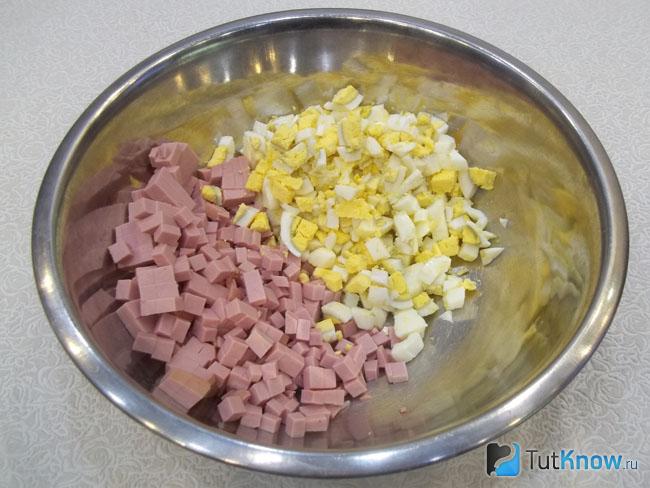 Отваренные яйца и колбаса нарезаны кубиками