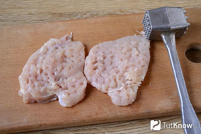 Два куска мяса отбиты на кухонной дощечке