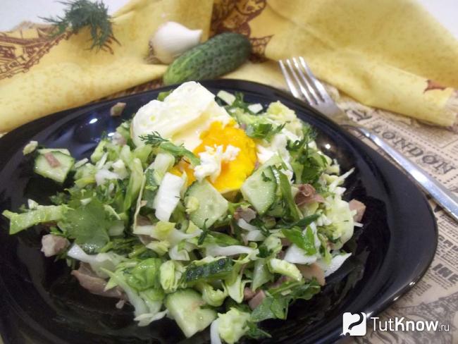 Готовый салат с рукколой, капустой, языком и яйцом-пашот