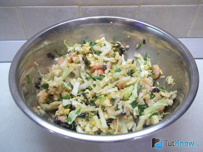 Готовый салат с креветками, капустой, сыром и яйцами